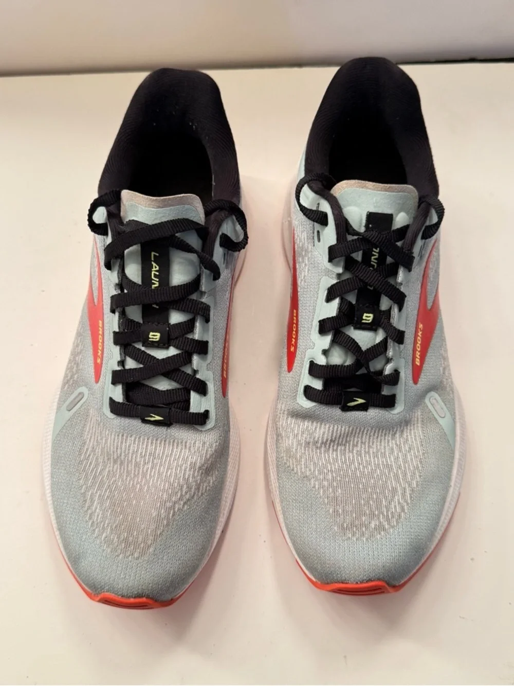 Brooks Light Gray Running Shoes with Red and Orange Accents